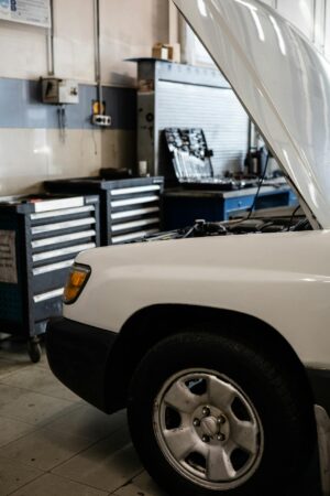 Auto repair reno vehicle with hood open as technician inspects engine from side view in repair shop